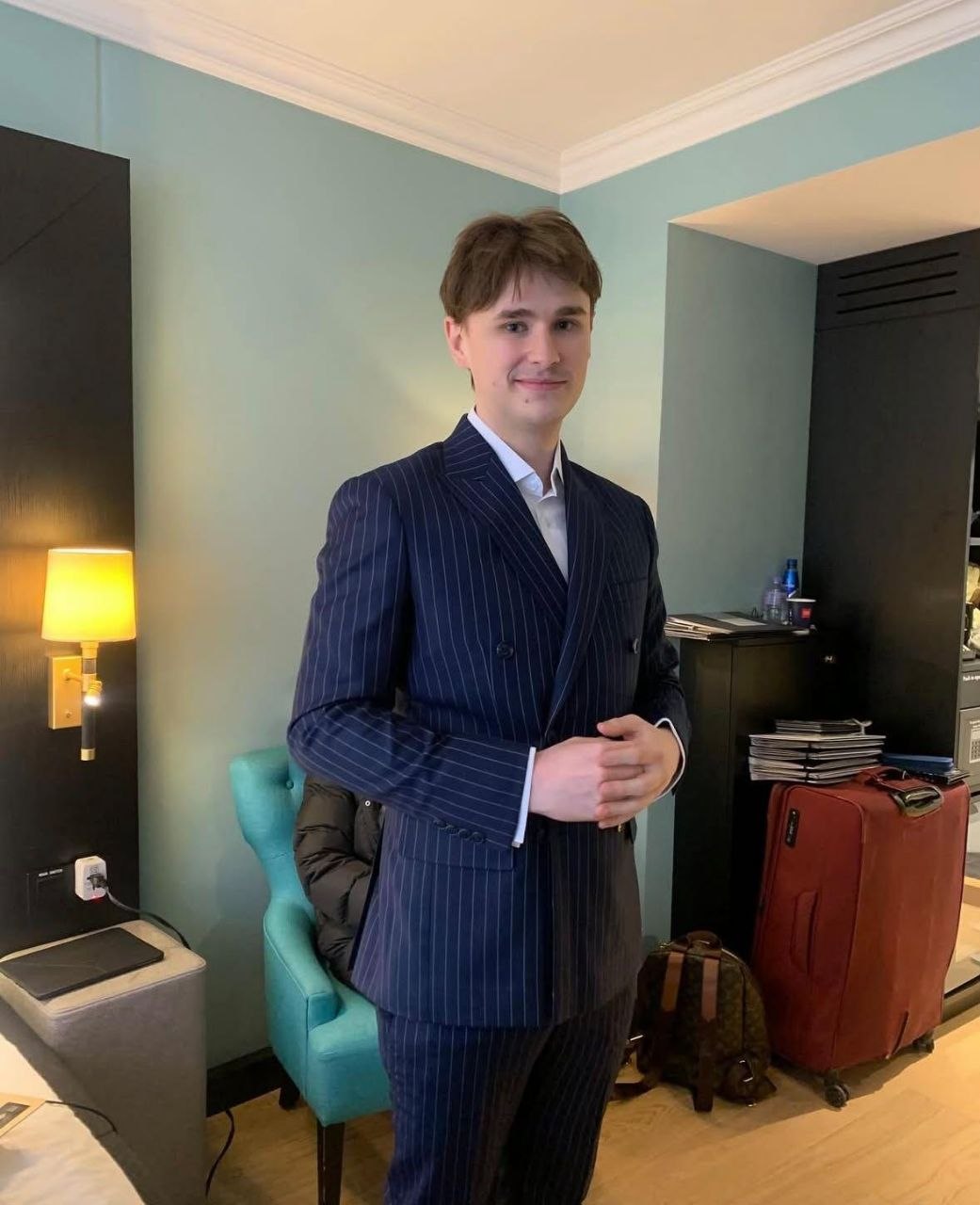 Real client photograph showing a finished navy pinstripe double breasted suit